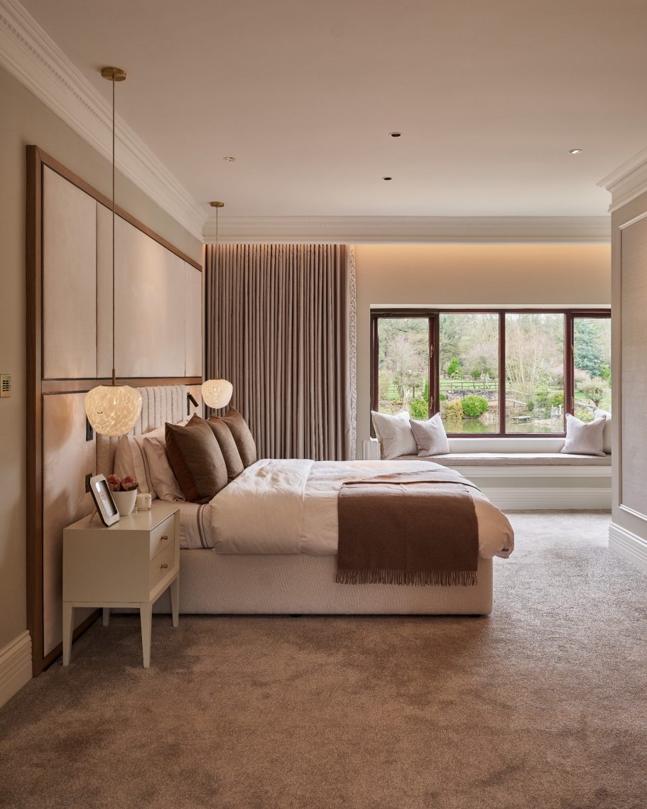 Stylish bedroom with a double bed, soft lighting, and large windows overlooking a garden.
