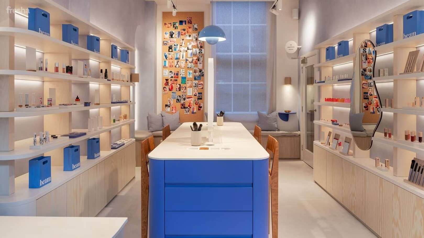 Brightly lit shop interior featuring blue accents and shelves displaying various products.